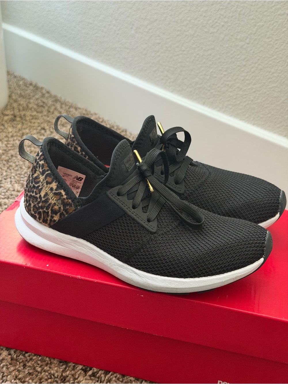 New Balance Women’s Black Sneakers with Leopard Heel Accent